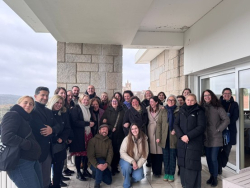 ​ Projekta Interreg Tourism4SDG 6. partneru vizītes dalībnieku grupas foto Valjadolidā, Spānijā. Cilveku grupa stāv pie akmens sienas, ziemas apģērbā, fonā redzama pilsētas ainava. ​